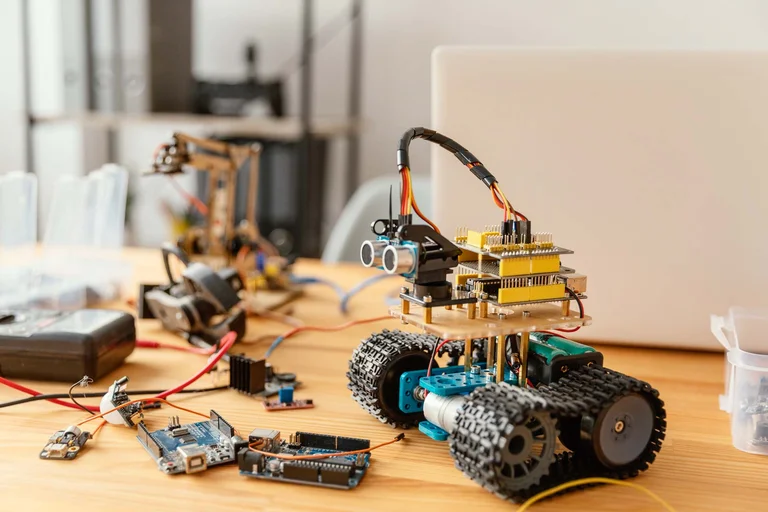 Students building and programming robots in robotics class